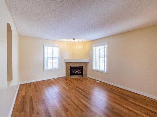 101 Westpoint Gardens, Calgary, AB - Indoor Photo Showing Living Room With Fireplace