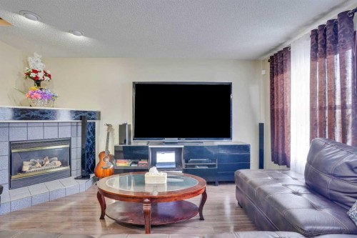 83 Bridlecreek Heath Sw, Calgary, AB - Indoor Photo Showing Living Room With Fireplace
