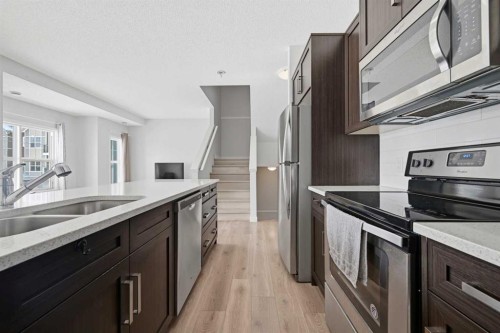 413-250 Fireside View, Cochrane, AB - Indoor Photo Showing Kitchen With Stainless Steel Kitchen With Double Sink With Upgraded Kitchen