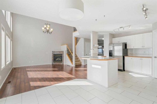 10 Arbour Stone Rise Nw, Calgary, AB - Indoor Photo Showing Kitchen With Fireplace