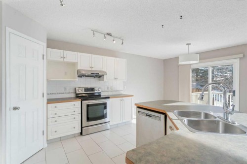 10 Arbour Stone Rise Nw, Calgary, AB - Indoor Photo Showing Kitchen With Double Sink