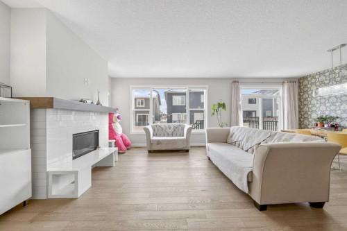 234 West Grove Point Sw, Calgary, AB - Indoor Photo Showing Living Room With Fireplace