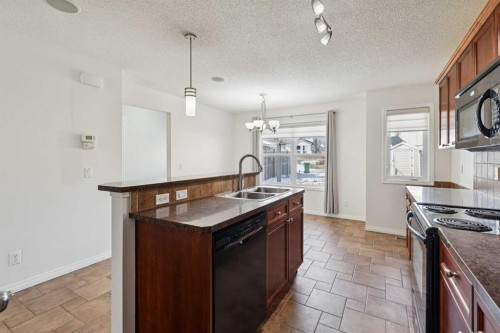 200 Silverado Drive Sw, Calgary, AB - Indoor Photo Showing Kitchen With Double Sink