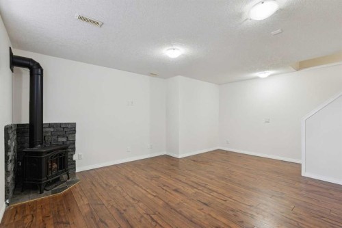 200 Silverado Drive Sw, Calgary, AB - Indoor Photo Showing Other Room With Fireplace