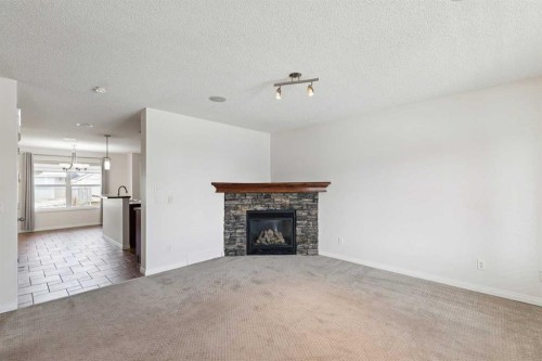200 Silverado Drive Sw, Calgary, AB - Indoor Photo Showing Living Room With Fireplace