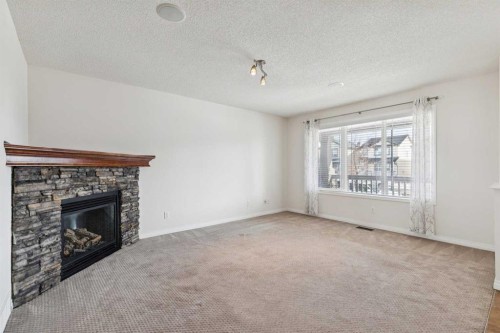 200 Silverado Drive Sw, Calgary, AB - Indoor Photo Showing Living Room With Fireplace
