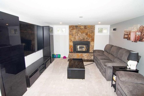 33233 Range Road 284, Rural Mountain View County, AB - Indoor Photo Showing Living Room With Fireplace