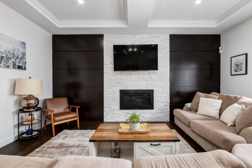 305 Kinniburgh Cove, Chestermere, AB - Indoor Photo Showing Living Room With Fireplace