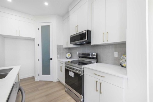 108 Heritage Manor, Cochrane, AB - Indoor Photo Showing Kitchen With Double Sink