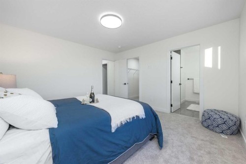 108 Heritage Manor, Cochrane, AB - Indoor Photo Showing Bedroom