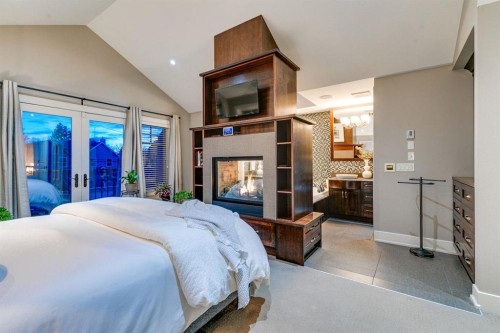 1727 Bowness Road Nw, Calgary, AB - Indoor Photo Showing Bedroom With Fireplace