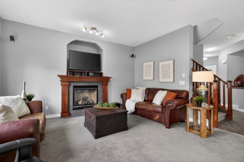 98 Evanscove Circle Nw, Calgary, AB - Indoor Photo Showing Living Room With Fireplace