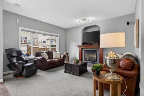 98 Evanscove Circle Nw, Calgary, AB - Indoor Photo Showing Living Room With Fireplace