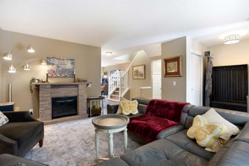 204 Eversyde Circle Sw, Calgary, AB - Indoor Photo Showing Living Room With Fireplace