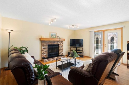 221 Scurfield Place Nw, Calgary, AB - Indoor Photo Showing Living Room With Fireplace