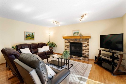 221 Scurfield Place Nw, Calgary, AB - Indoor Photo Showing Living Room With Fireplace