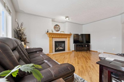 115 Cove Crescent, Chestermere, AB - Indoor Photo Showing Living Room With Fireplace