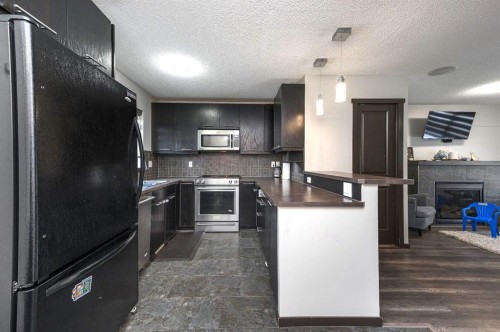 702 Panamount Boulevard Nw, Calgary, AB - Indoor Photo Showing Kitchen With Upgraded Kitchen