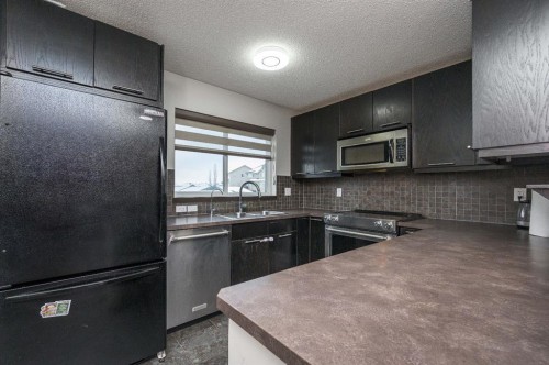 702 Panamount Boulevard Nw, Calgary, AB - Indoor Photo Showing Kitchen With Double Sink