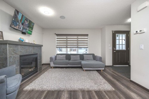 702 Panamount Boulevard Nw, Calgary, AB - Indoor Photo Showing Living Room With Fireplace