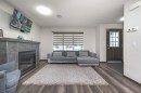 702 Panamount Boulevard Nw, Calgary, AB  - Indoor Photo Showing Living Room With Fireplace 
