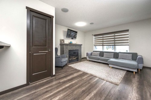 702 Panamount Boulevard Nw, Calgary, AB - Indoor Photo Showing Living Room With Fireplace
