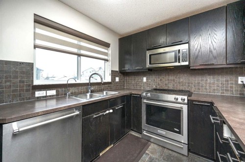 702 Panamount Boulevard Nw, Calgary, AB - Indoor Photo Showing Kitchen With Double Sink