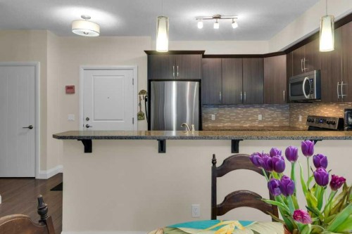 2104-15 Sunset Square, Cochrane, AB - Indoor Photo Showing Kitchen With Stainless Steel Kitchen With Upgraded Kitchen