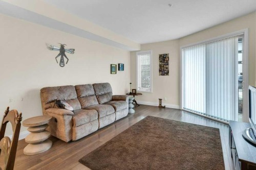 2104-15 Sunset Square, Cochrane, AB - Indoor Photo Showing Living Room