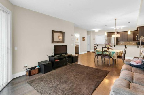 2104-15 Sunset Square, Cochrane, AB - Indoor Photo Showing Living Room