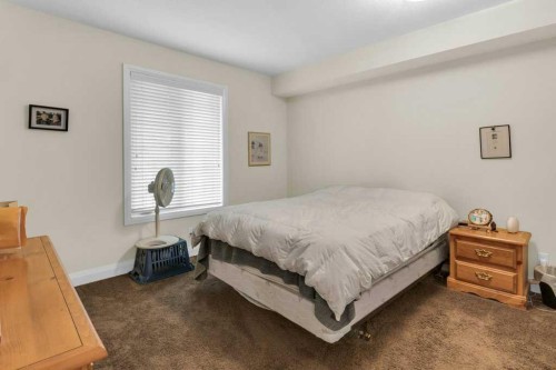 2104-15 Sunset Square, Cochrane, AB - Indoor Photo Showing Bedroom