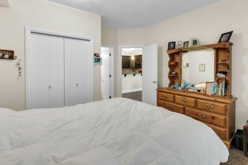 2104-15 Sunset Square, Cochrane, AB - Indoor Photo Showing Bedroom