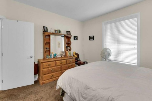 2104-15 Sunset Square, Cochrane, AB - Indoor Photo Showing Bedroom