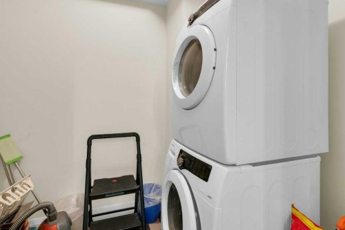 2104-15 Sunset Square, Cochrane, AB - Indoor Photo Showing Laundry Room