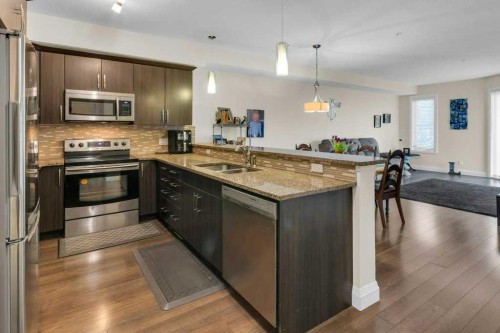 2104-15 Sunset Square, Cochrane, AB - Indoor Photo Showing Kitchen With Stainless Steel Kitchen With Double Sink