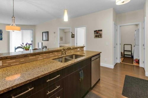 2104-15 Sunset Square, Cochrane, AB - Indoor Photo Showing Kitchen With Double Sink