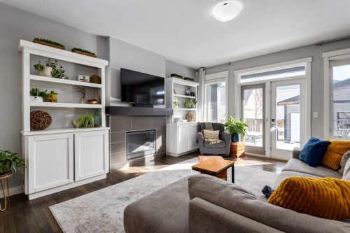306 Cooperstown Common Sw, Airdrie, AB - Indoor Photo Showing Living Room With Fireplace