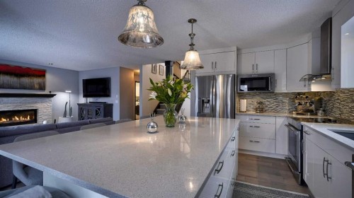 125 Riverview Place Se, Calgary, AB - Indoor Photo Showing Kitchen With Fireplace With Double Sink With Upgraded Kitchen