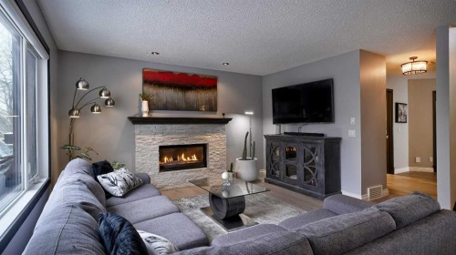 125 Riverview Place Se, Calgary, AB - Indoor Photo Showing Living Room With Fireplace