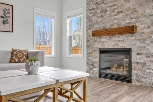 19 Bridleridge Green Sw, Calgary, AB - Indoor Photo Showing Living Room With Fireplace