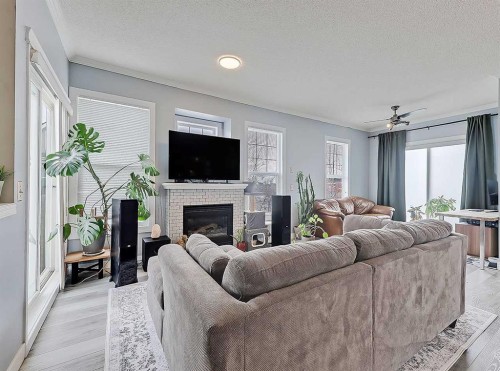 104 Prestwick Gardens Se, Calgary, AB - Indoor Photo Showing Living Room With Fireplace