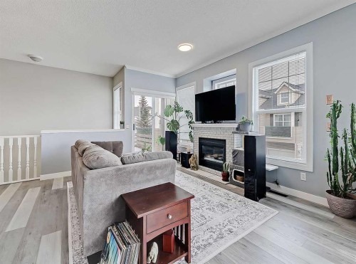 104 Prestwick Gardens Se, Calgary, AB - Indoor Photo Showing Living Room With Fireplace