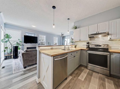 104 Prestwick Gardens Se, Calgary, AB - Indoor Photo Showing Kitchen With Stainless Steel Kitchen With Upgraded Kitchen