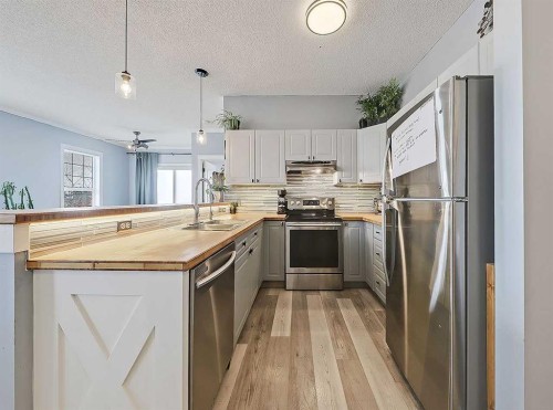 104 Prestwick Gardens Se, Calgary, AB - Indoor Photo Showing Kitchen With Stainless Steel Kitchen With Upgraded Kitchen