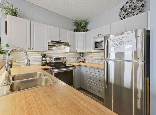 104 Prestwick Gardens Se, Calgary, AB - Indoor Photo Showing Kitchen With Stainless Steel Kitchen With Double Sink With Upgraded Kitchen