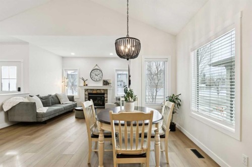 852 Everridge Drive Sw, Calgary, AB - Indoor Photo Showing Dining Room With Fireplace
