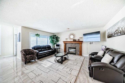 41 Covette Bay Ne, Calgary, AB - Indoor Photo Showing Living Room With Fireplace