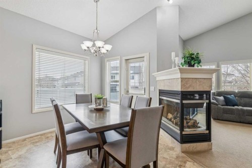 328 Cove Road, Chestermere, AB - Indoor Photo Showing Dining Room With Fireplace