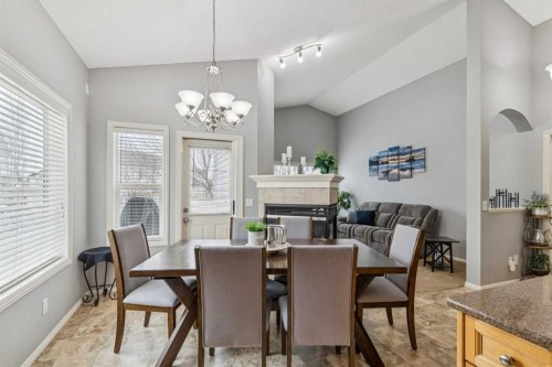 328 Cove Road, Chestermere, AB - Indoor Photo Showing Dining Room With Fireplace