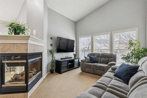 328 Cove Road, Chestermere, AB - Indoor Photo Showing Living Room With Fireplace
